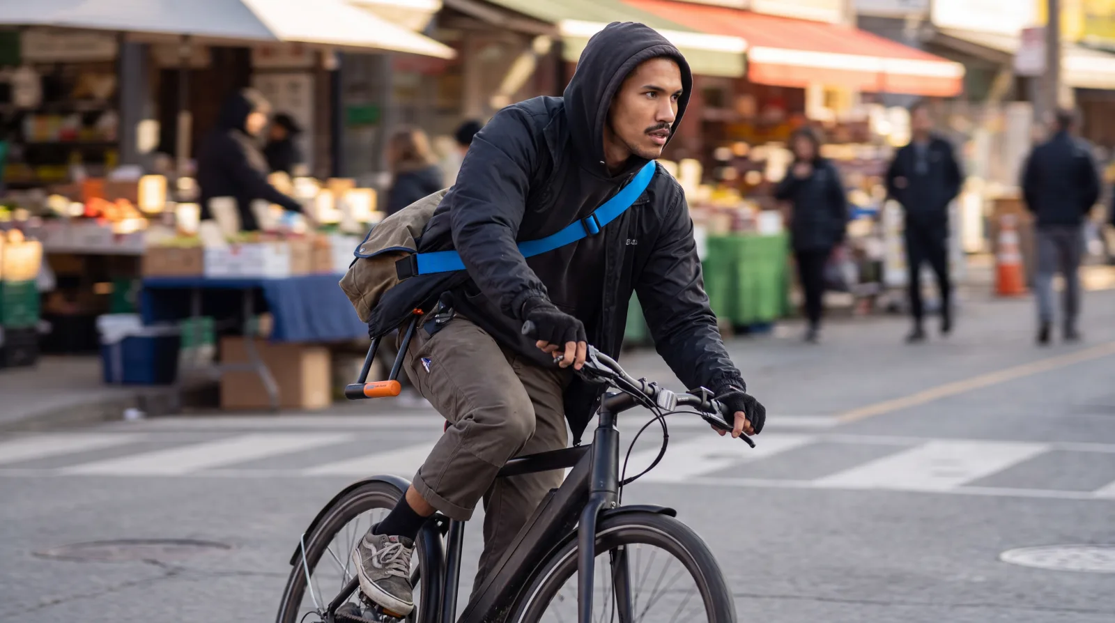 A rider pedaling a fast commuter e-bike on a city street bike lane